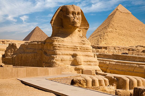 istockphoto-178375366-612×612 A beautiful profile of the Great Sphinx including the pyramids of Menkaure and Khafre in the background in Giza, Cairo, Egypt